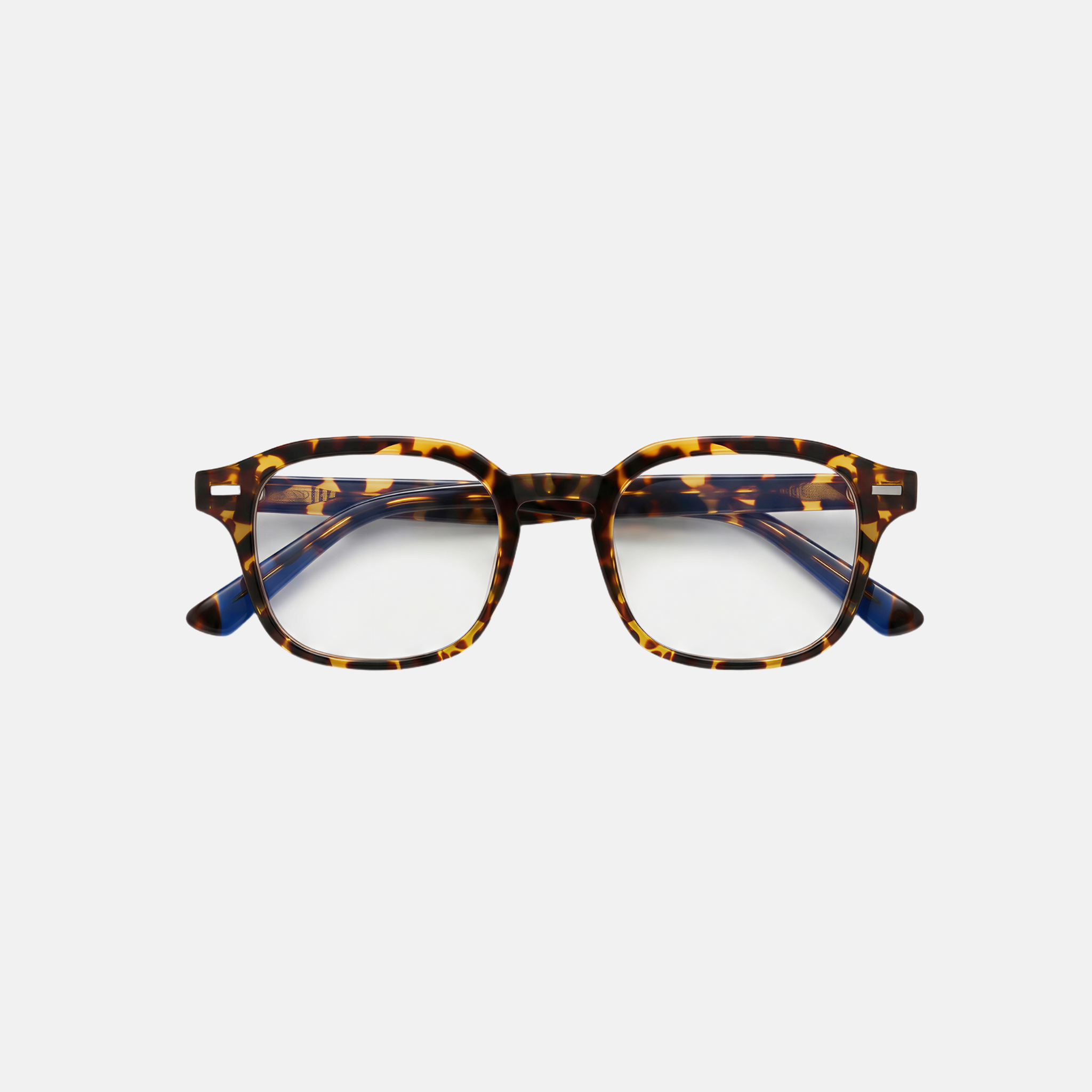 Tortoiseshell eyeglasses on a light gray background